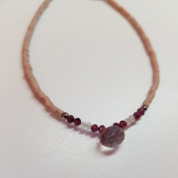 Beaded droplet bracelet. Smokey quartz droplet with garnet and moonstone beads on a mat pink glass beads.